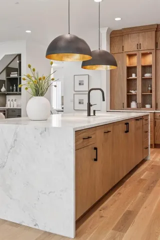 a dining room with furniture wooden floor and a chandelier