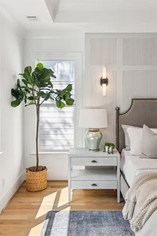 a view of a hallway with wooden floor and chandelier