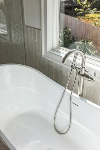 a bathroom with a granite countertop sink a toilet and shower
