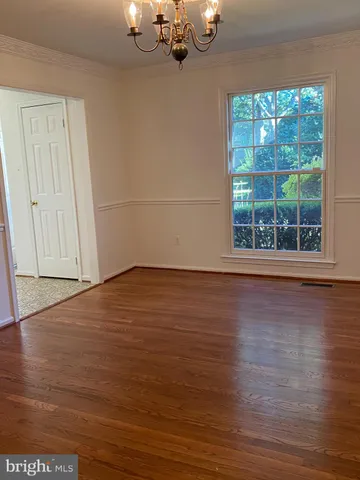 a view of a room with wooden floor and window