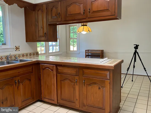 a kitchen with granite countertop cabinets stainless steel appliances a sink and a window