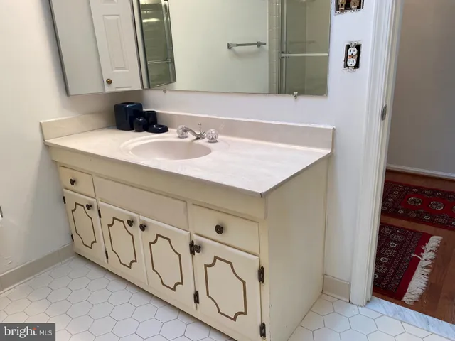 a bathroom with a sink and a mirror