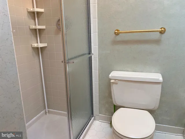 a white toilet sitting next to a bathroom sink