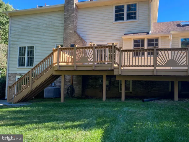 a view of a house with a yard and deck