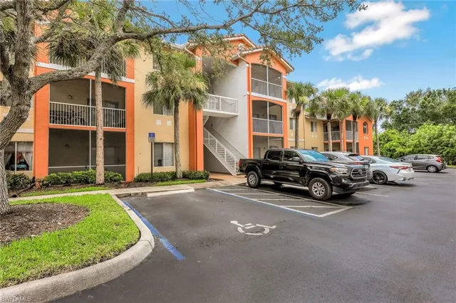 a car parked in front of a brick house with a yard
