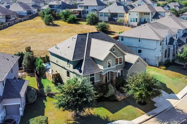 an aerial view of a house with a swimming pool
