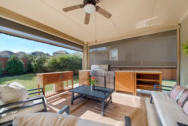 a outdoor living space with furniture and a rug