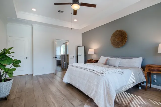 a bedroom with a bed and a potted plant