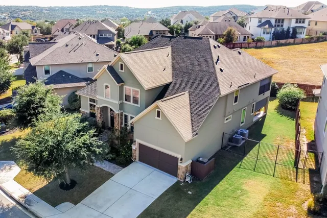 an aerial view of residential houses with yard