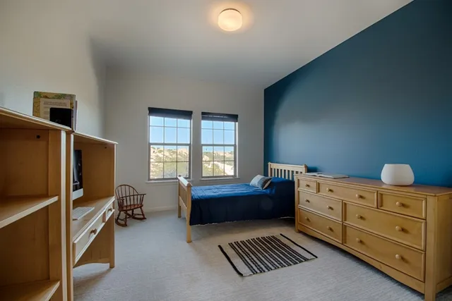 a bedroom with furniture and a window