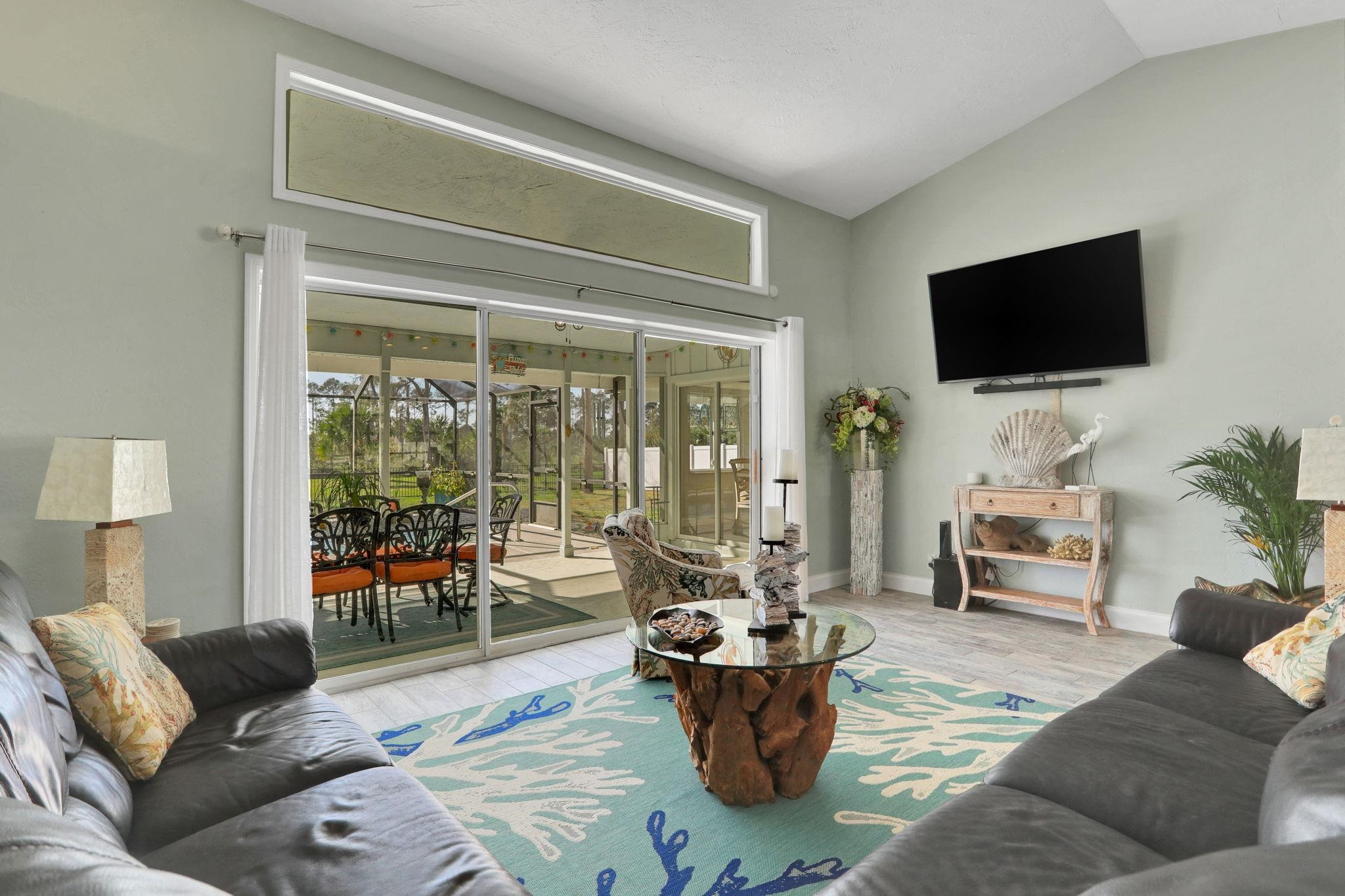 1075 Lambert Avenue Flagler Beach, FL 32136 - Photo 13 of 71 a living room with furniture and a flat screen tv