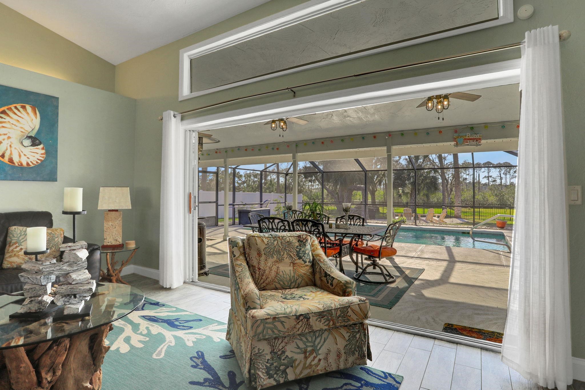 1075 Lambert Avenue Flagler Beach, FL 32136 - Photo 14 of 71 a living room with furniture and a window