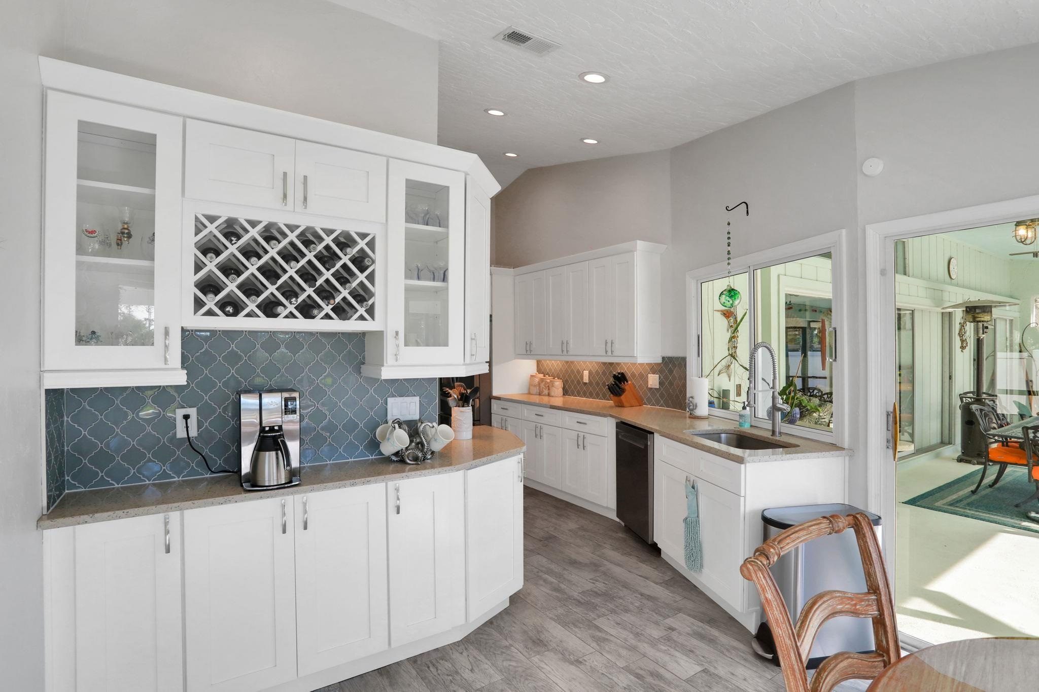1075 Lambert Avenue Flagler Beach, FL 32136 - Photo 20 of 71 a kitchen with stainless steel appliances a sink stove and cabinets