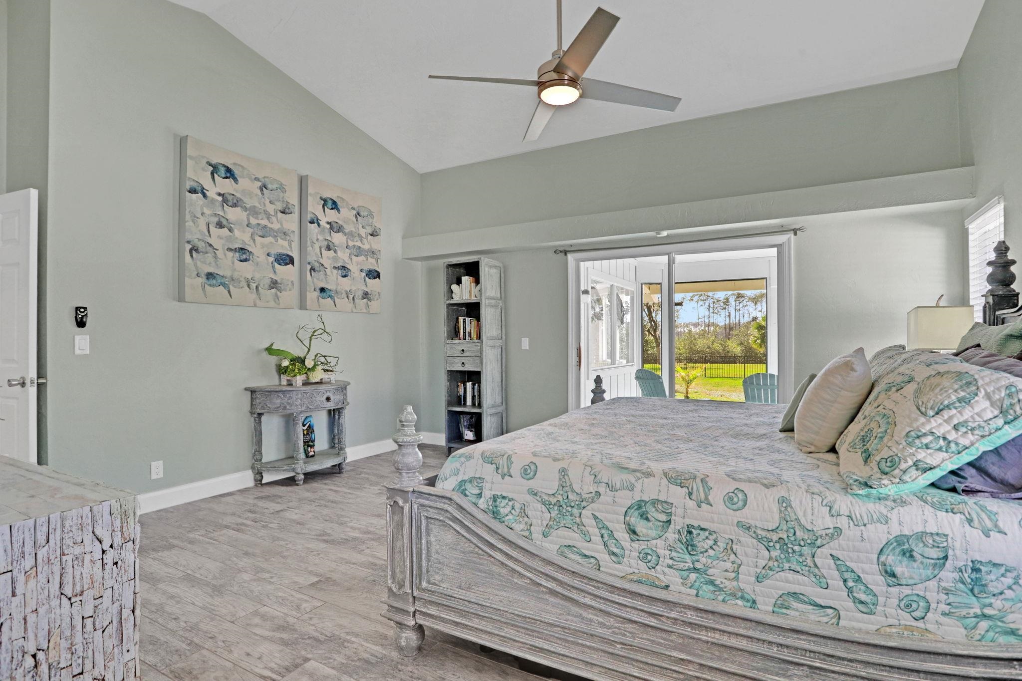 1075 Lambert Avenue Flagler Beach, FL 32136 - Photo 26 of 71 a bedroom with a bed and a table