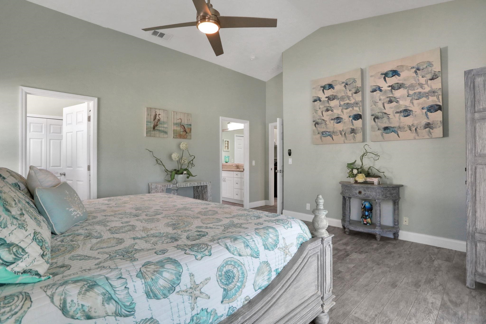 1075 Lambert Avenue Flagler Beach, FL 32136 - Photo 27 of 71 a bedroom with a bed and a chandelier