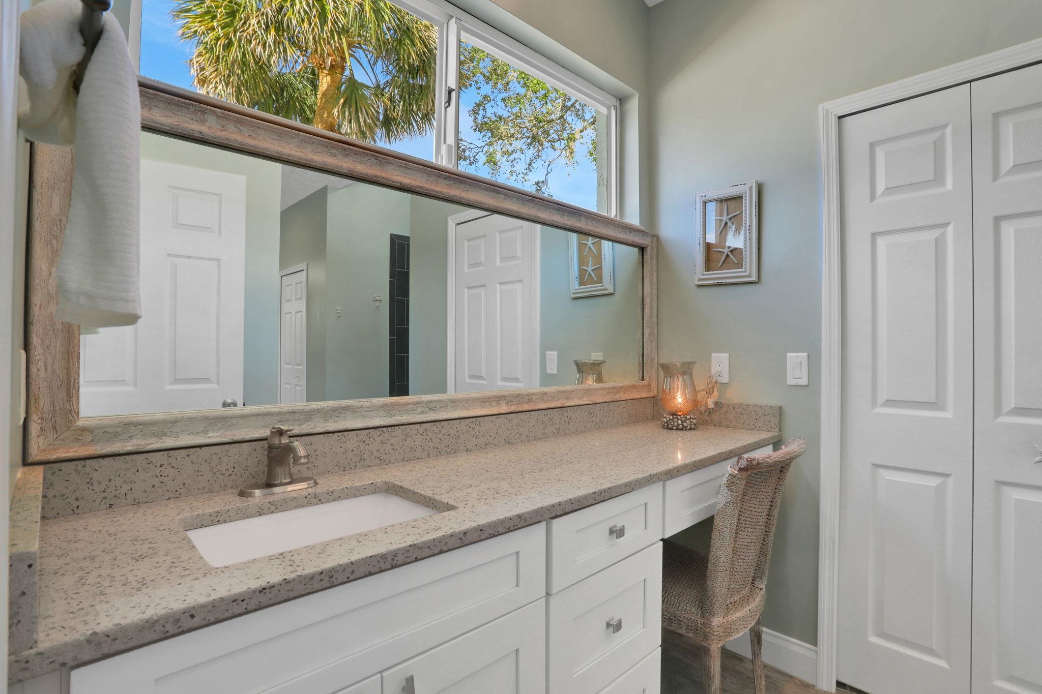 1075 Lambert Avenue Flagler Beach, FL 32136 - Photo 29 of 71 a bathroom with a granite countertop sink and a mirror