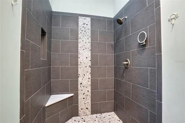 a view of a dining room with furniture and a chandelier fan