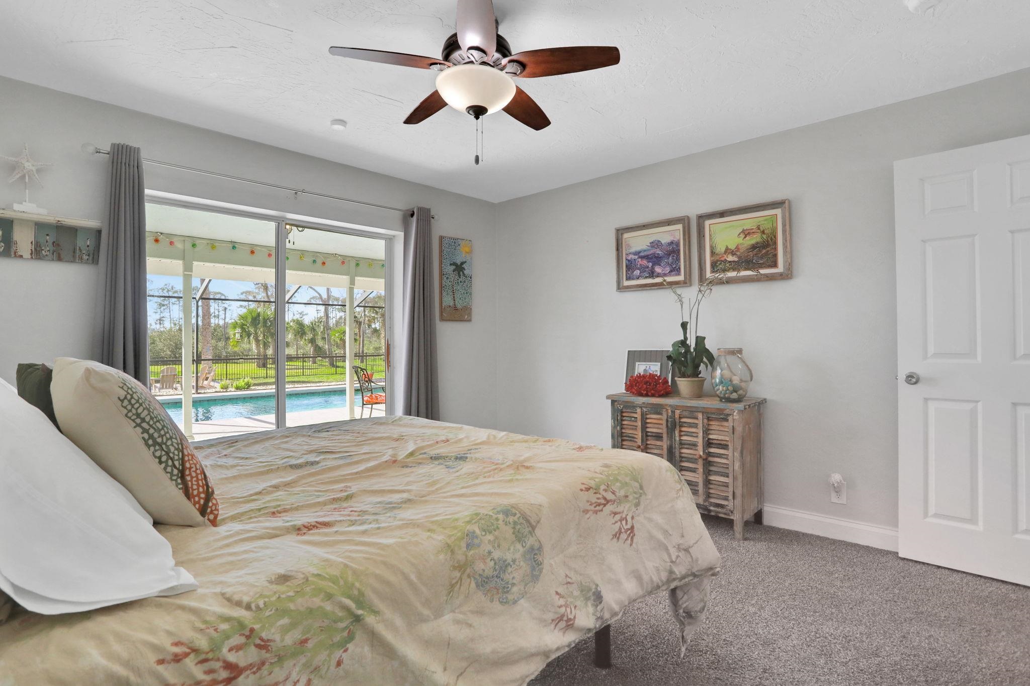 1075 Lambert Avenue Flagler Beach, FL 32136 - Photo 36 of 71 a bedroom with a bed dresser and a window