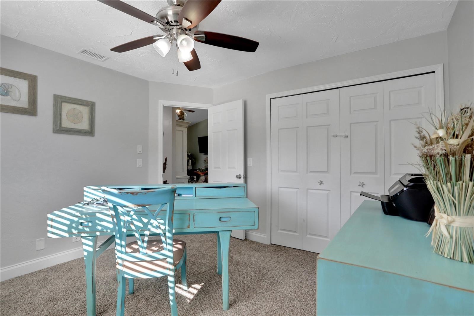1075 Lambert Avenue Flagler Beach, FL 32136 - Photo 39 of 71 a view of a dining room with furniture and a chandelier fan
