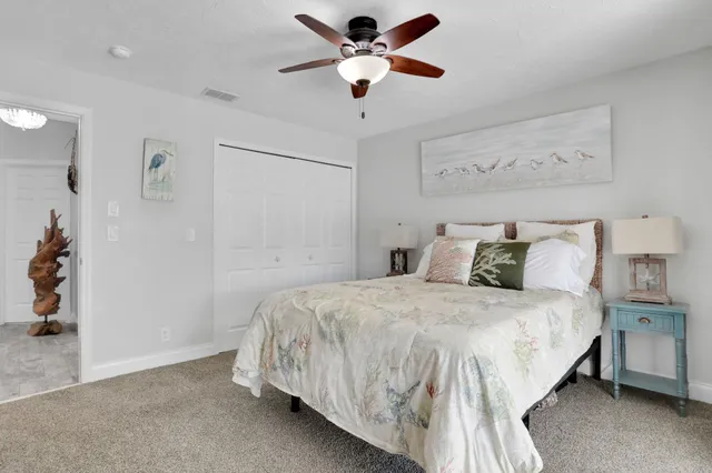 a view of a swimming pool with a lounge chair and palm trees