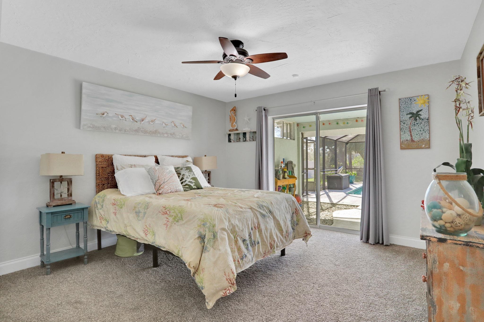 1075 Lambert Avenue Flagler Beach, FL 32136 - Photo 42 of 71 a bed room with a bed and a chandelier