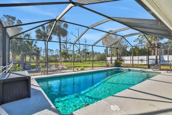 a backyard of a house with table and chairs