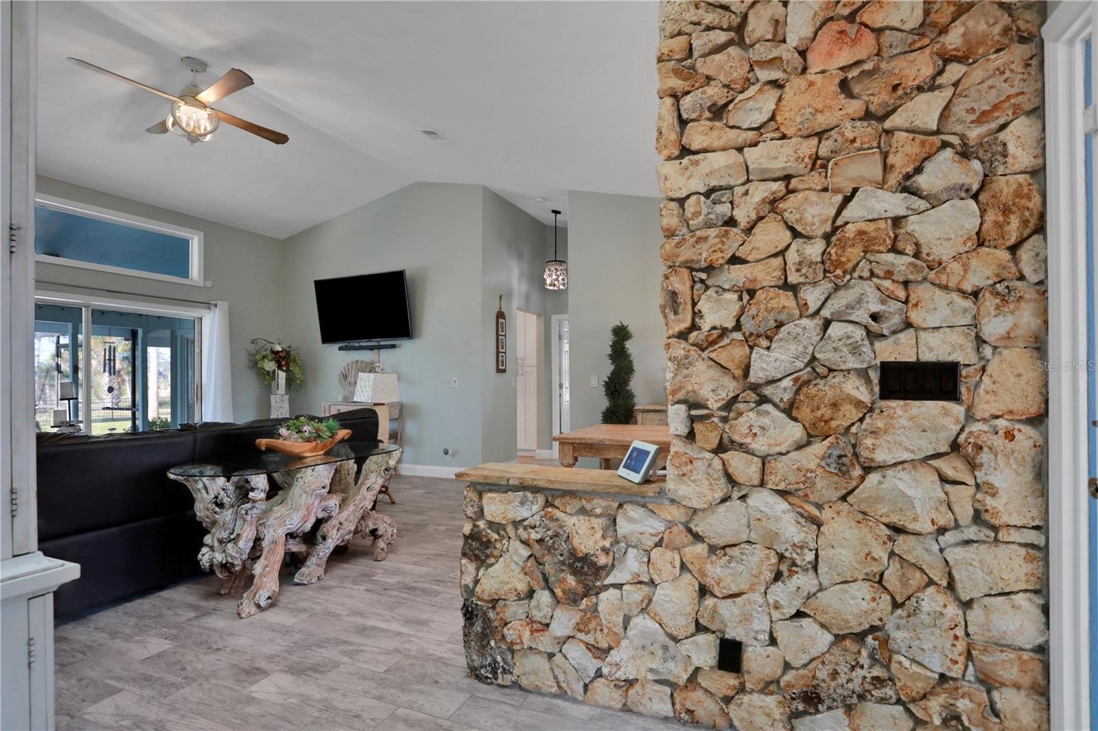 1075 Lambert Avenue Flagler Beach, FL 32136 - Photo 5 of 71 a living room with furniture and a flat screen tv