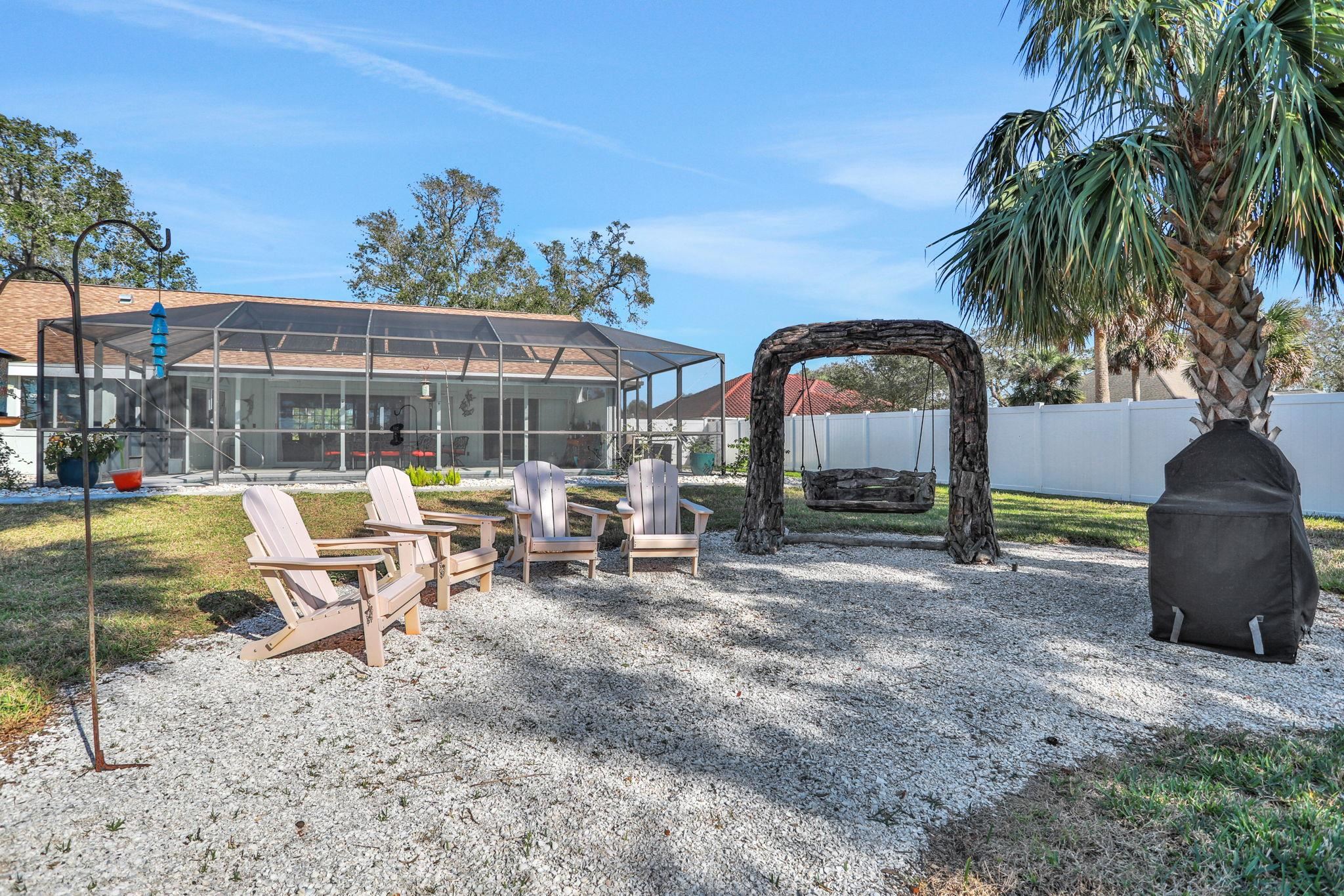 1075 Lambert Avenue Flagler Beach, FL 32136 - Photo 53 of 71 a view of a swimming pool with a lounge chair and palm trees