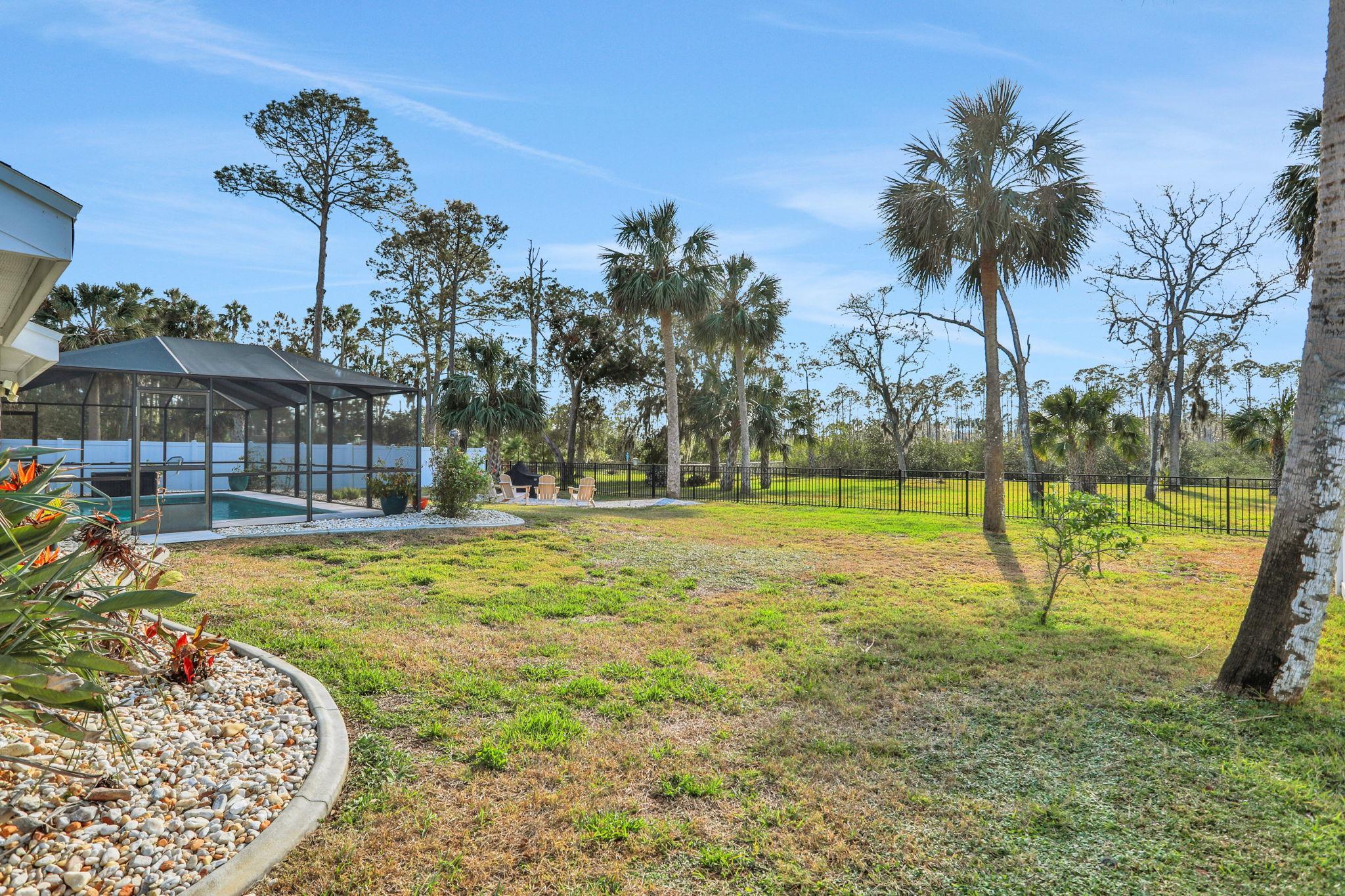 1075 Lambert Avenue Flagler Beach, FL 32136 - Photo 55 of 71 a swimming pool with outdoor seating and garden