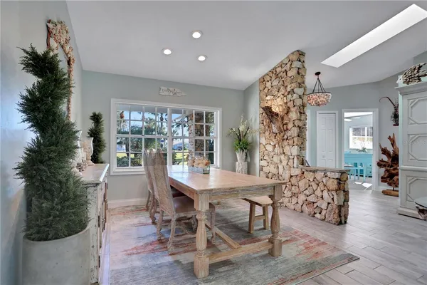 a dining room with furniture and wooden floor