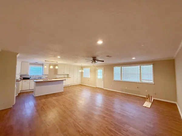 a large space with a large window and wooden floor