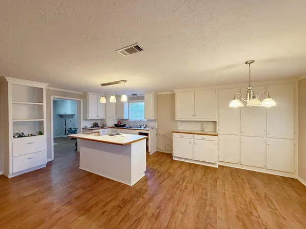 a kitchen with a sink and a stove top oven