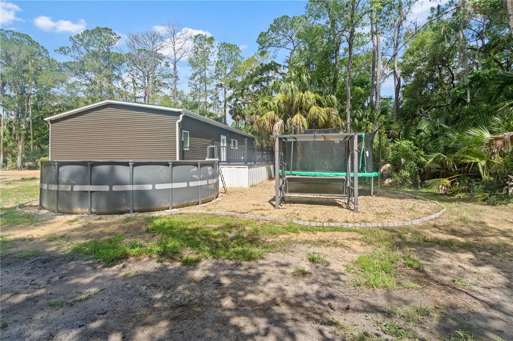 375 Sapp Street Inglis, FL 34449 - Photo 30 of 36 a backyard of a house with table and chairs