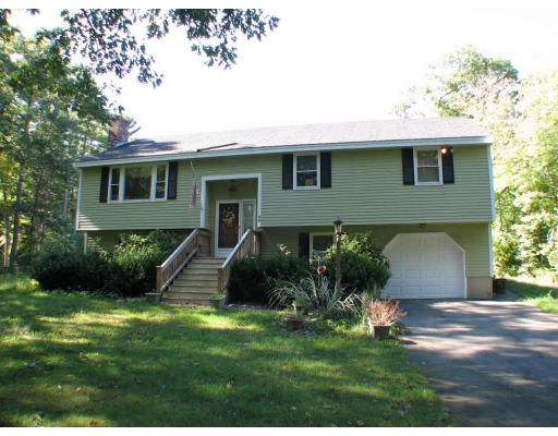 49 Baldpate Road Georgetown, MA 01833 - Photo 1 of 13 a front view of a house with a yard and green space