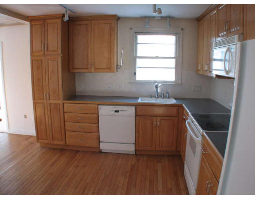 49 Baldpate Road Georgetown, MA 01833 - Photo 4 of 13 a kitchen with granite countertop wooden cabinets a sink and a stove