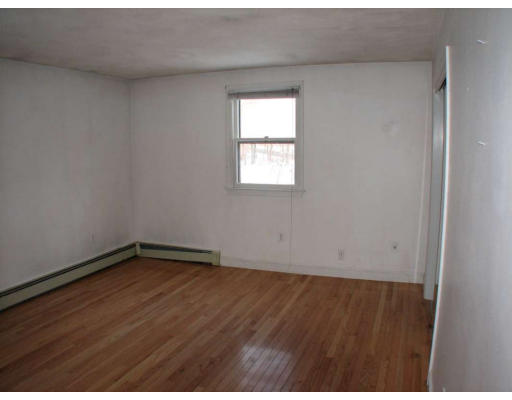 49 Baldpate Road Georgetown, MA 01833 - Photo 8 of 13 an empty room with wooden floor and windows