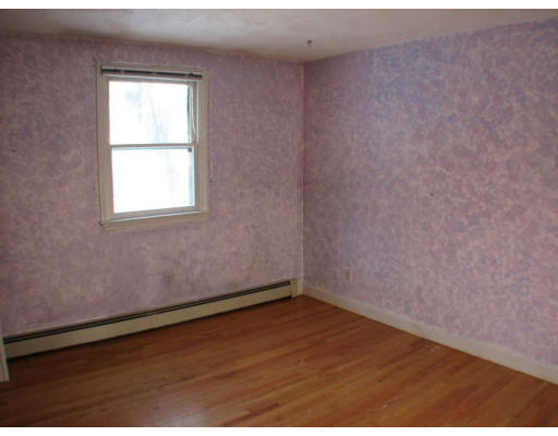 49 Baldpate Road Georgetown, MA 01833 - Photo 9 of 13 an empty room with wooden floor and windows