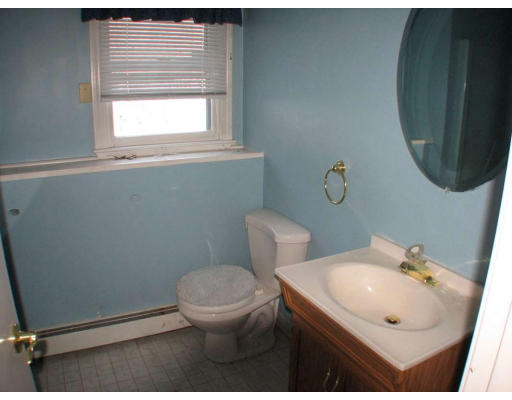 49 Baldpate Road Georgetown, MA 01833 - Photo 10 of 13 a bathroom with a sink toilet and a mirror