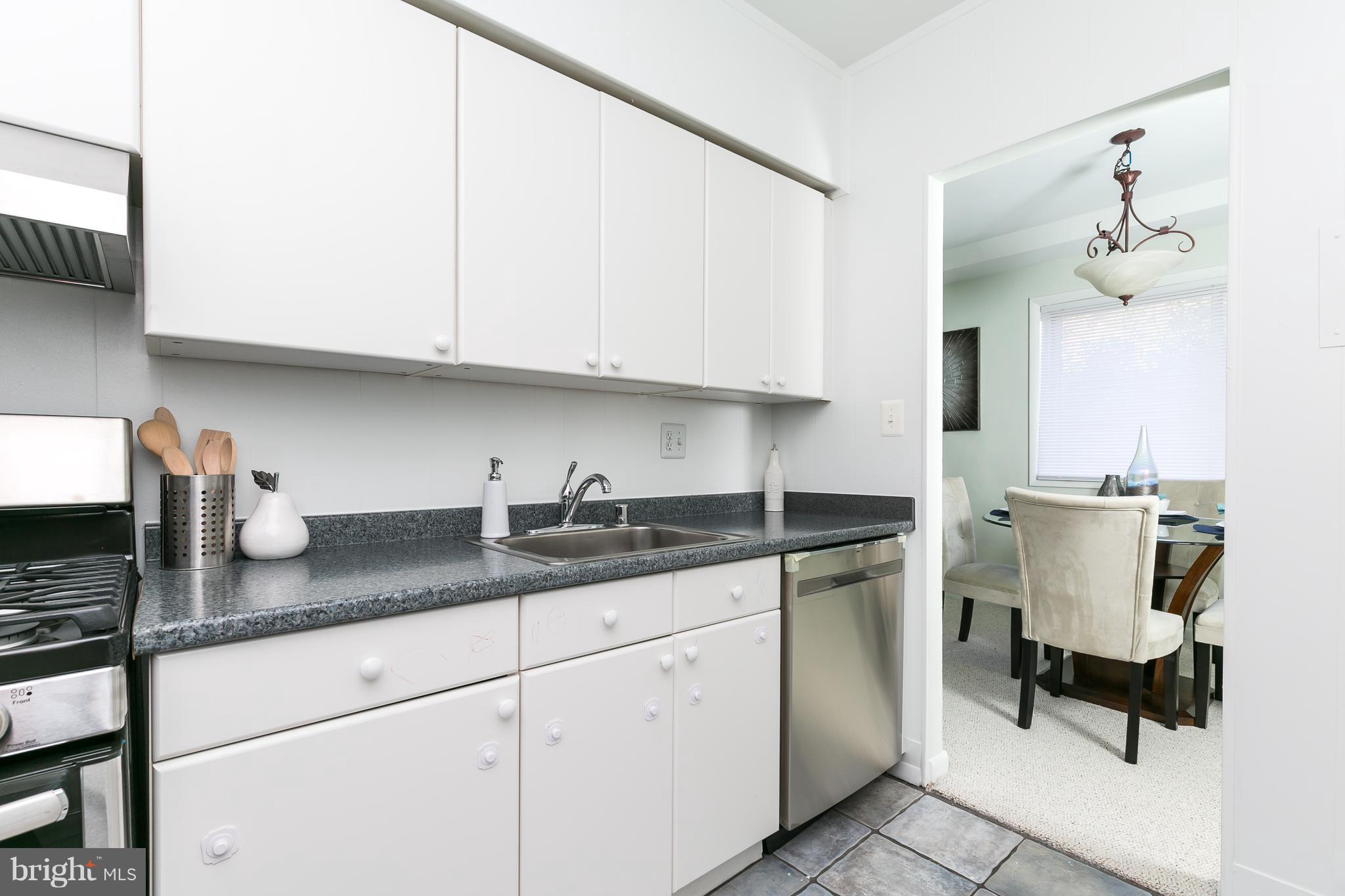 5101 8th Road South, Unit 7 Arlington, VA 22204 - Photo 13 of 32 a kitchen with granite countertop white cabinets and white appliances