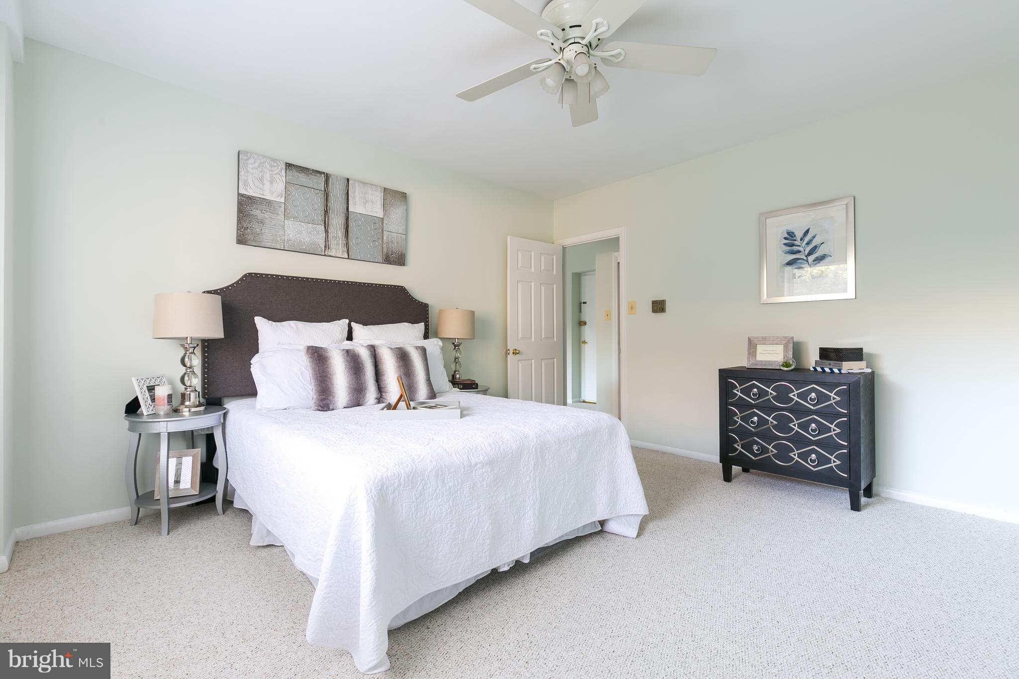 5101 8th Road South, Unit 7 Arlington, VA 22204 - Photo 15 of 32 a bedroom with a bed and a chandelier