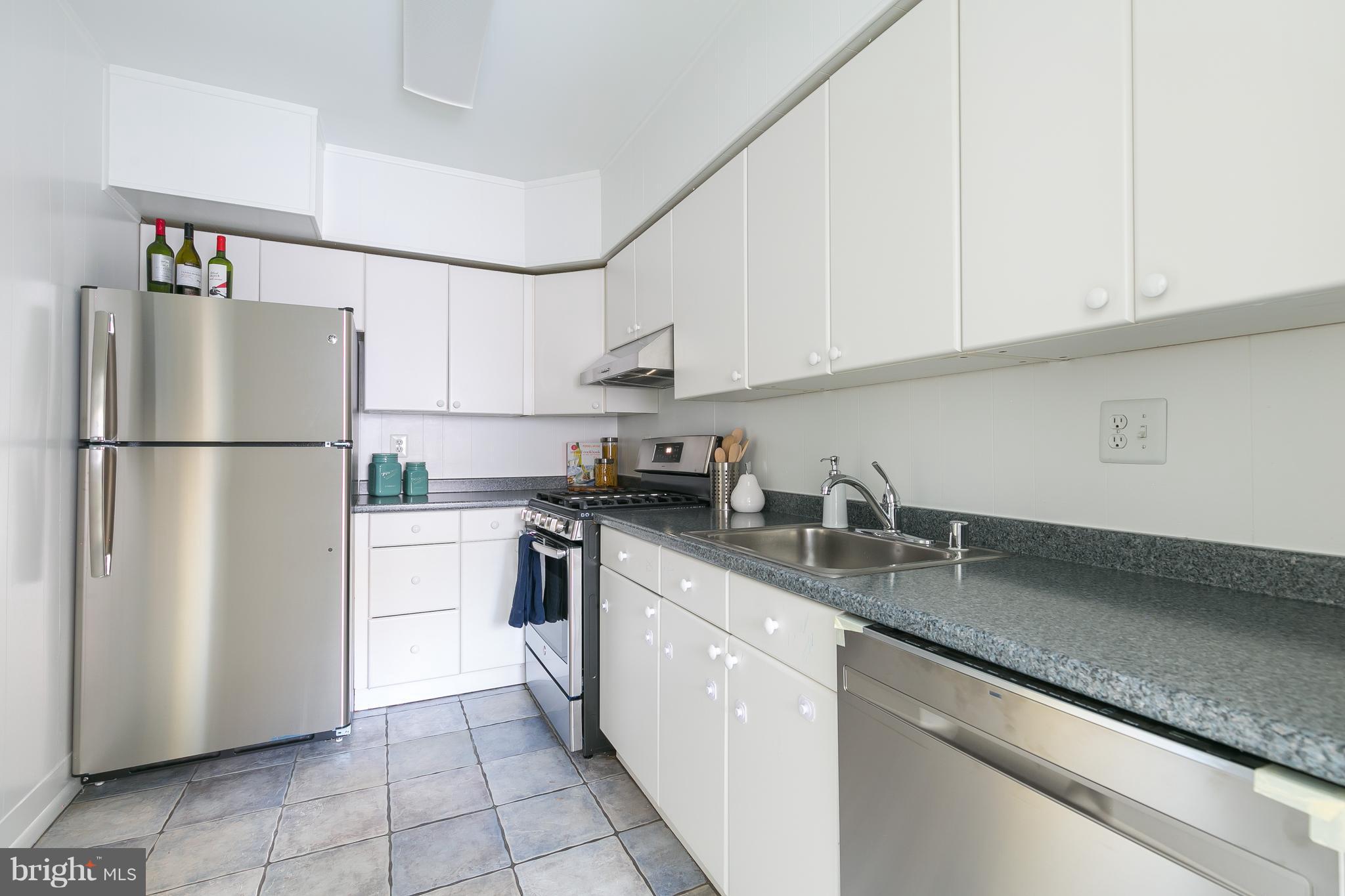 5101 8th Road South, Unit 7 Arlington, VA 22204 - Photo 10 of 32 a kitchen with stainless steel appliances granite countertop a refrigerator sink and cabinets