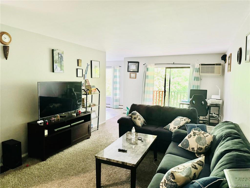 3(33J) Hook Road, Unit 14E Poughkeepsie, NY 12601 - Photo 2 of 12 a living room with furniture and a flat screen tv