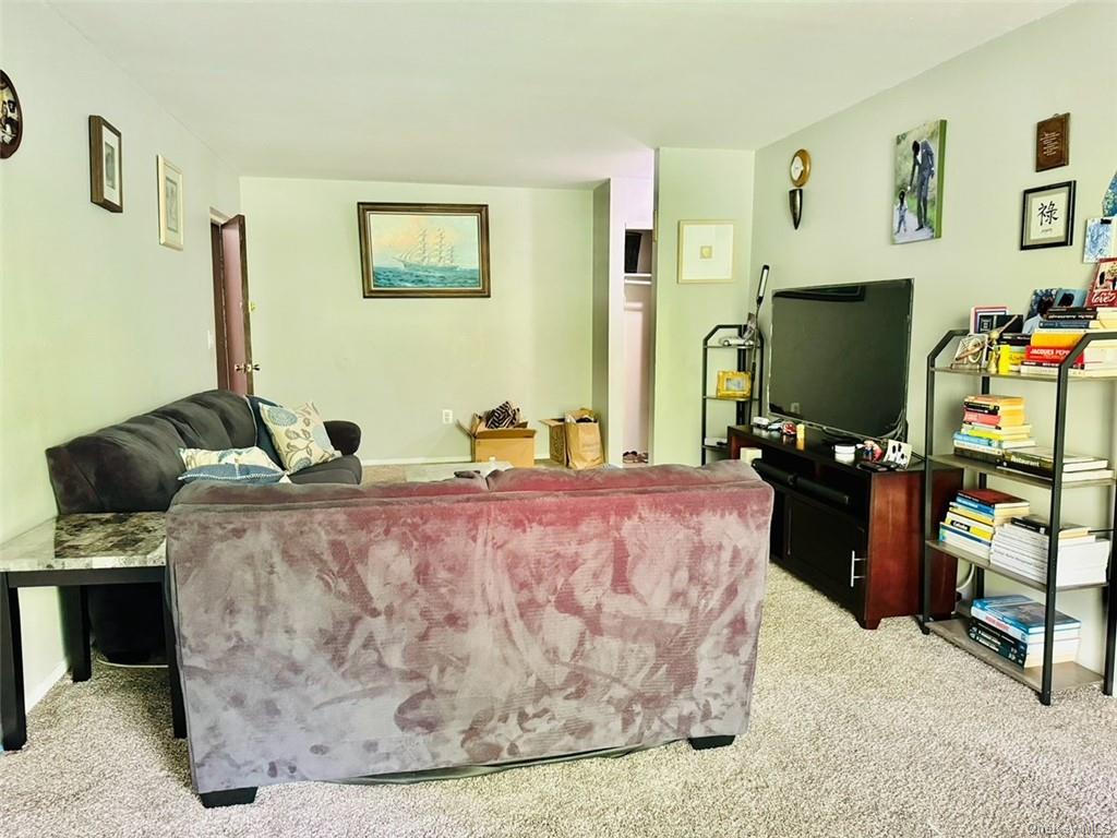 3(33J) Hook Road, Unit 14E Poughkeepsie, NY 12601 - Photo 3 of 12 a living room with furniture and a flat screen tv