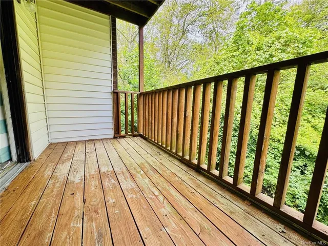 a view of a balcony with wooden floor