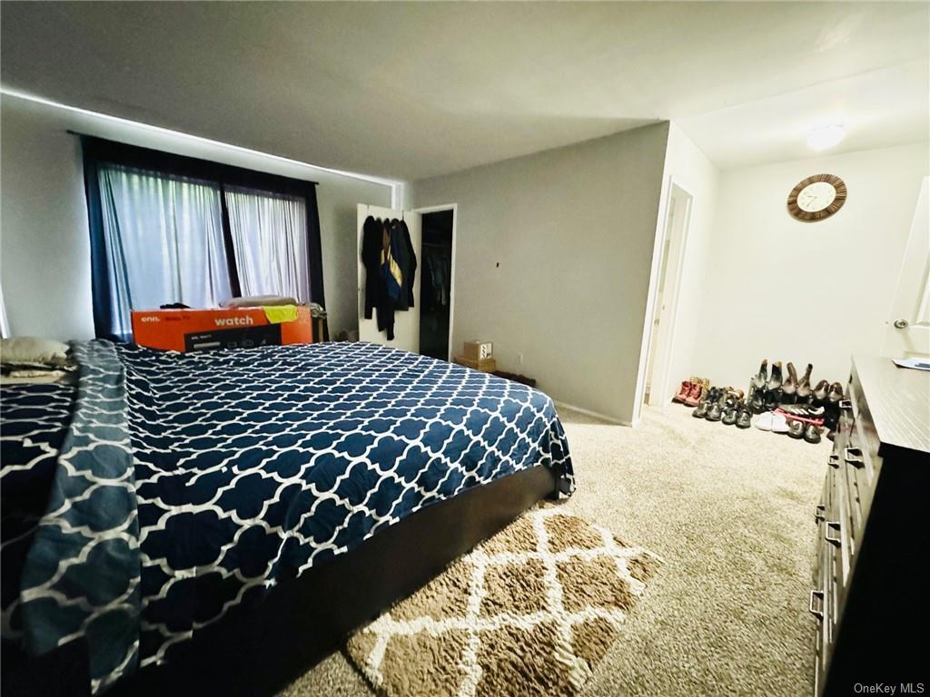 3(33J) Hook Road, Unit 14E Poughkeepsie, NY 12601 - Photo 7 of 12 a bedroom with a bed and a window