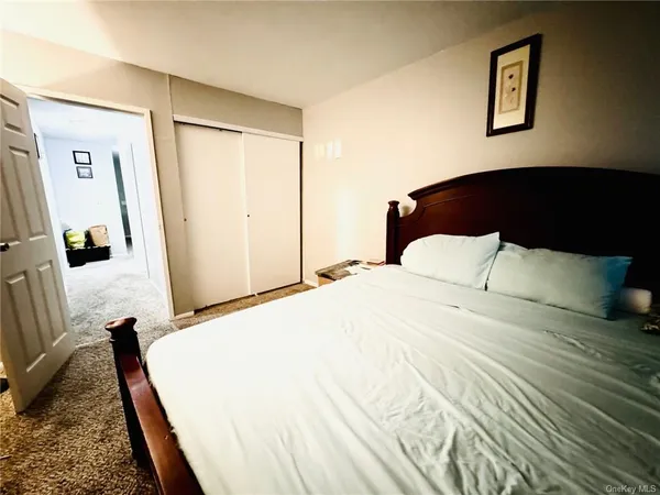 a bedroom with a bed and a large mirror