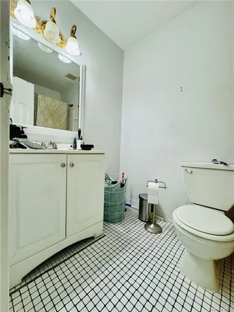 a bathroom with a sink toilet and mirror