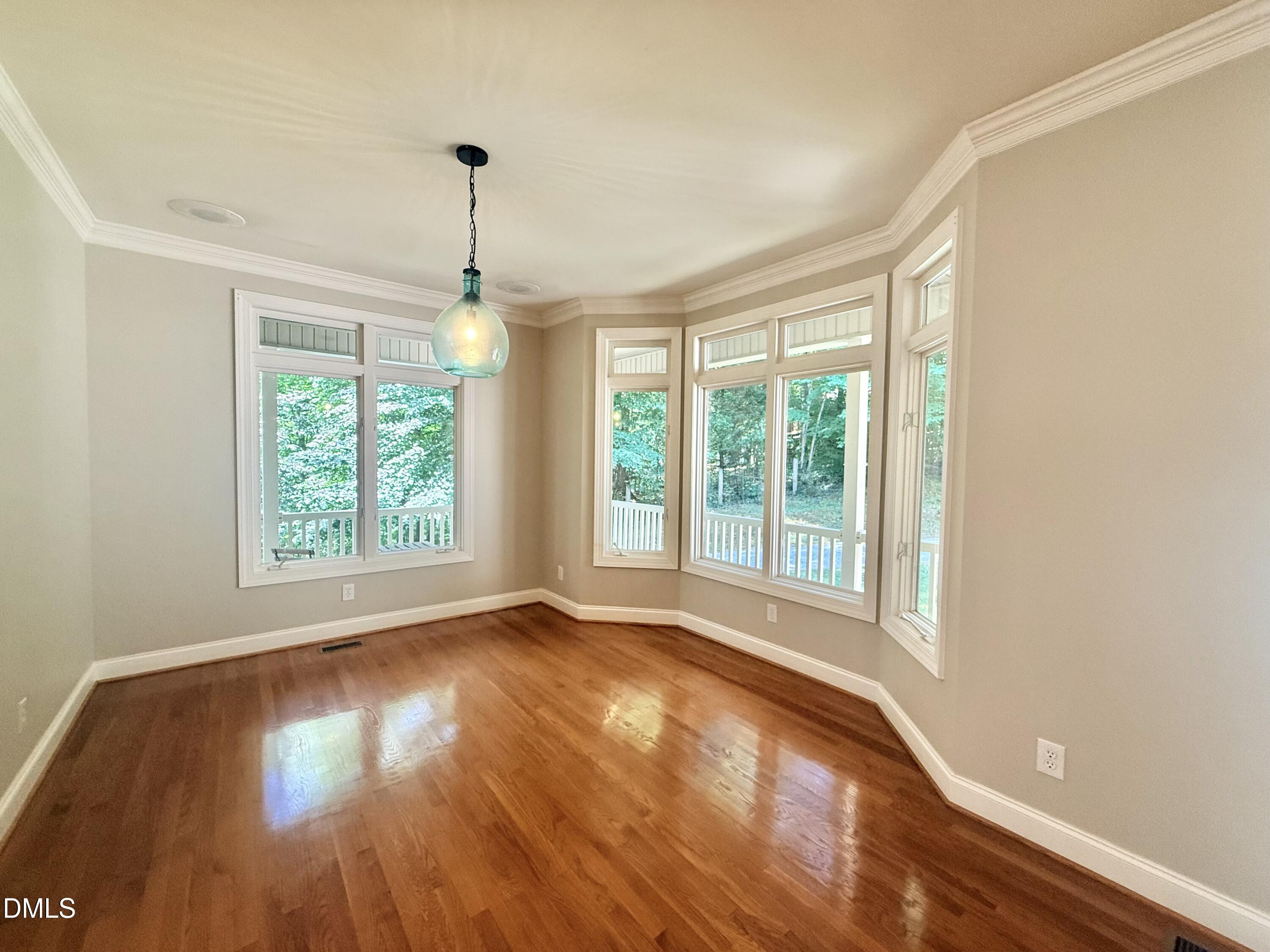 81 Beaver Crossing Road Roxboro, NC 27574 - Photo 19 of 80 a view of an empty room with wooden floor and a window