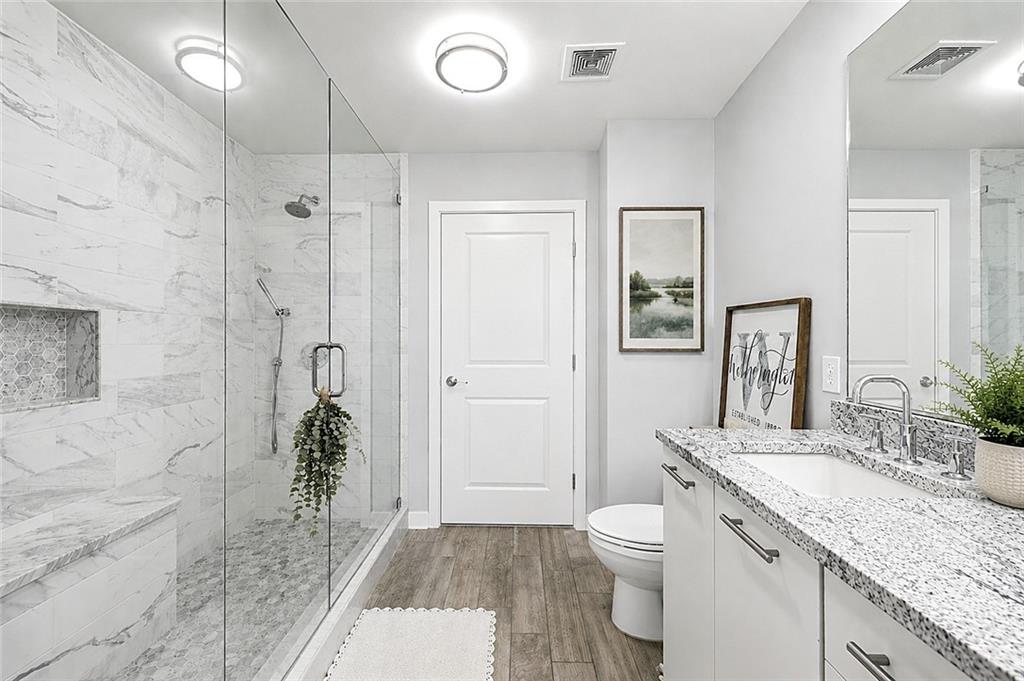 3300 Windy Ridge Parkway Southeast, Unit 1112 Atlanta, GA 30339 - Photo 3 of 43 a spacious bathroom with a granite countertop sink toilet and shower