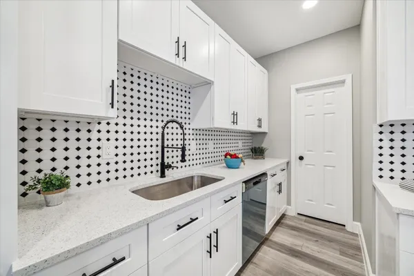 a kitchen with a sink a stove and cabinets